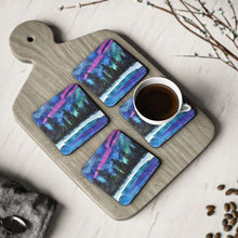 Load image into Gallery viewer, Corkwood underside, glossy finish on top. Available in 1 or 4 pc sets. 9.5 x 9.5cm. Northern lights, Aurora Borealis, snow
